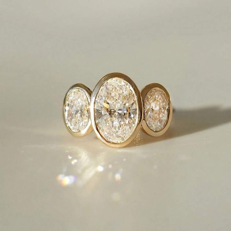 Gilded Circle Harmony 18K Gold Bezel-Set Three-Stone Ring