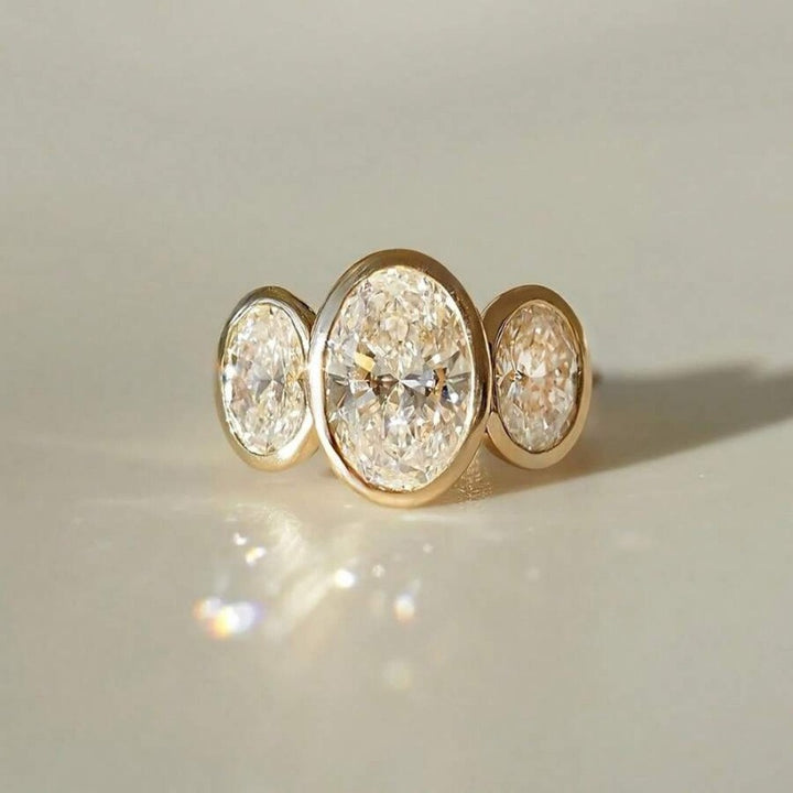 Gilded Circle Harmony 18K Gold Bezel-Set Three-Stone Ring