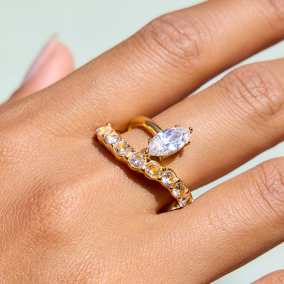 Gold Ring with Marquise - Shaped Central Stone and Curved Design